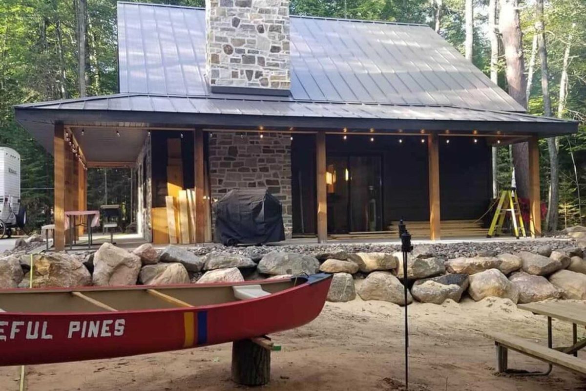 A cabin with a stone chimney in the woods 