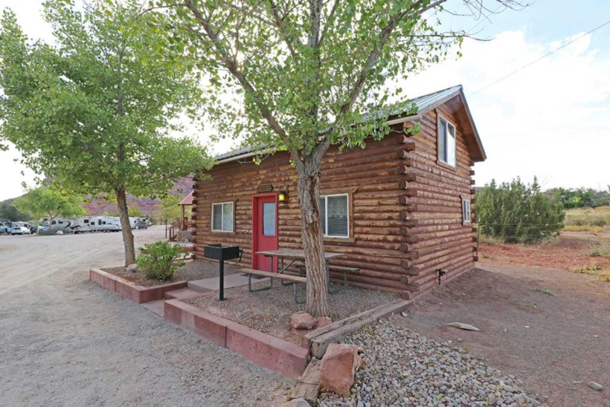 A log cabin at Sun Outdoors Canyonlands Gateway,  a campground with cabins 