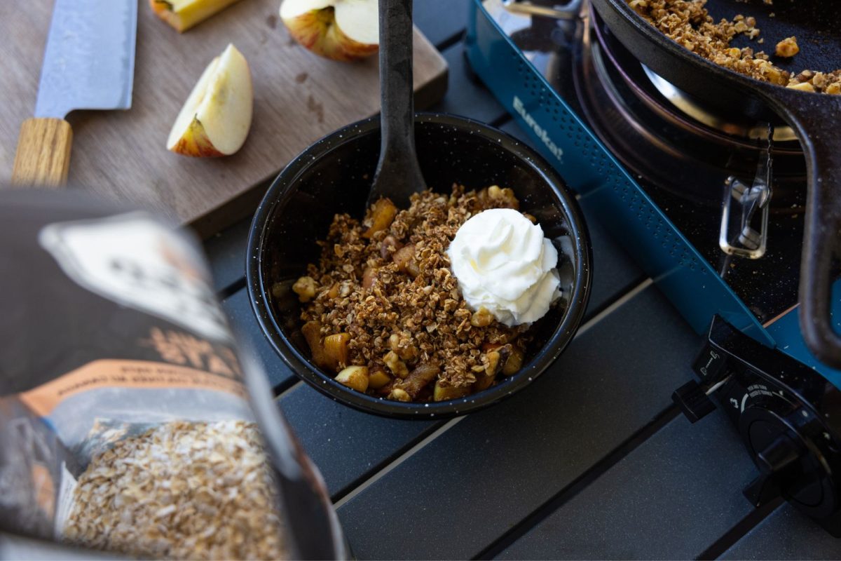 Maple apple crisp in a bowl with whipped cream 