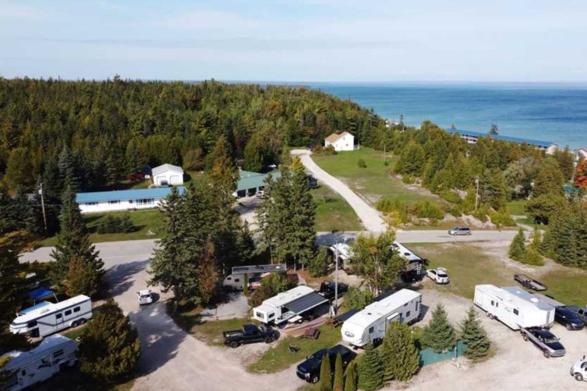 campground near mackinaw city, MI with RVs by trees and water