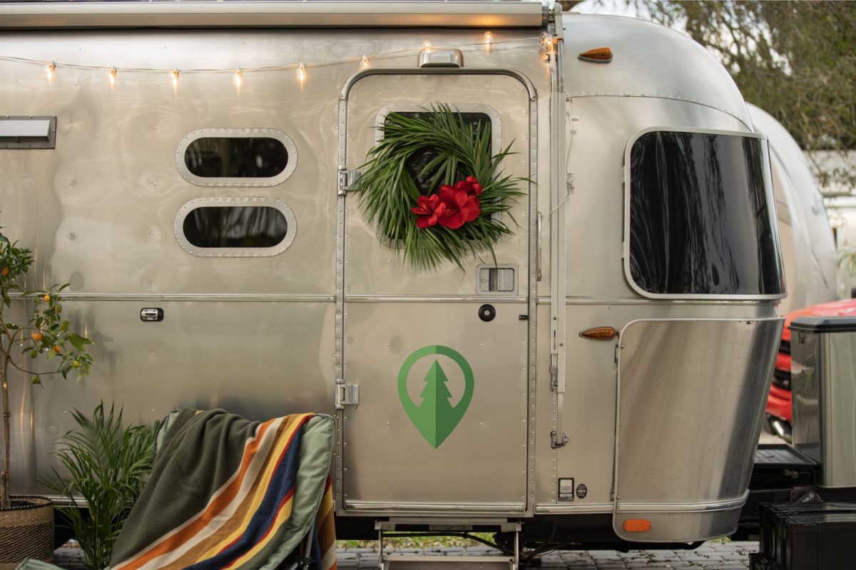 a wreath hanging on the door as an RV Christmas decoration