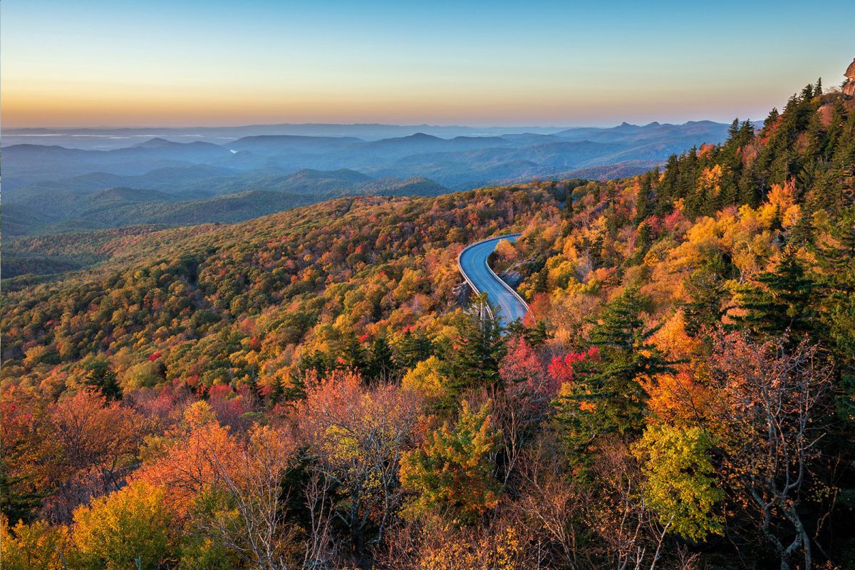 The Blue Ridge Parkway road through fall colored trees, one of the best places to camp