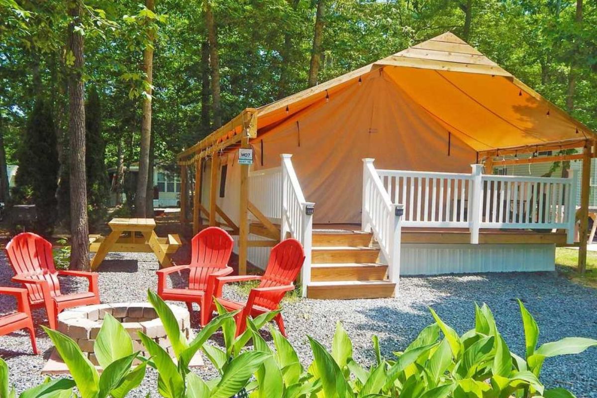 chairs, firepit, and tent lodge at campground near Cape May