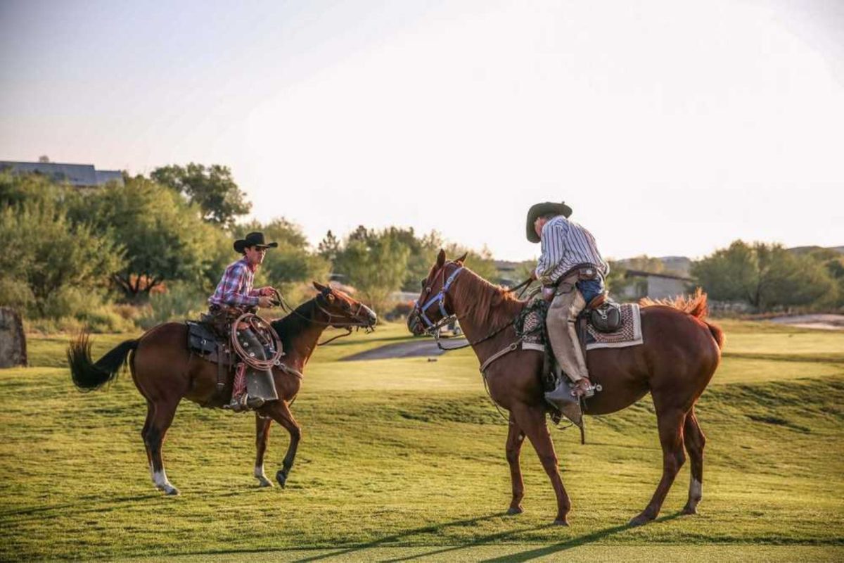 two men on horses at campground