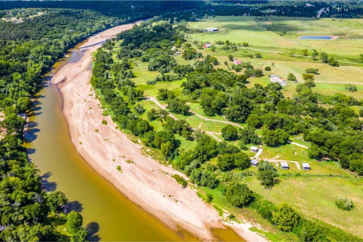 Brazos River running alongside lush green campground near Fort Worth, TX