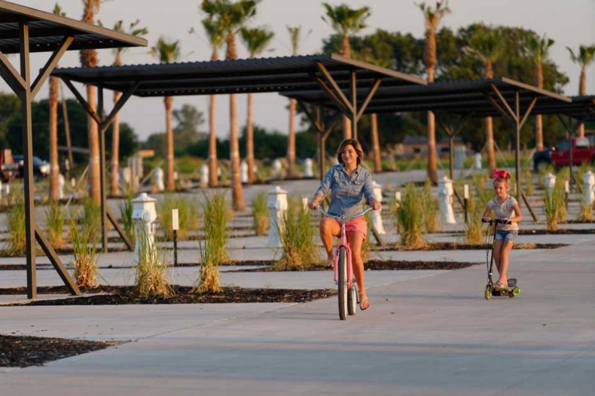 mother and daughter biking and riding scooters at RV campground