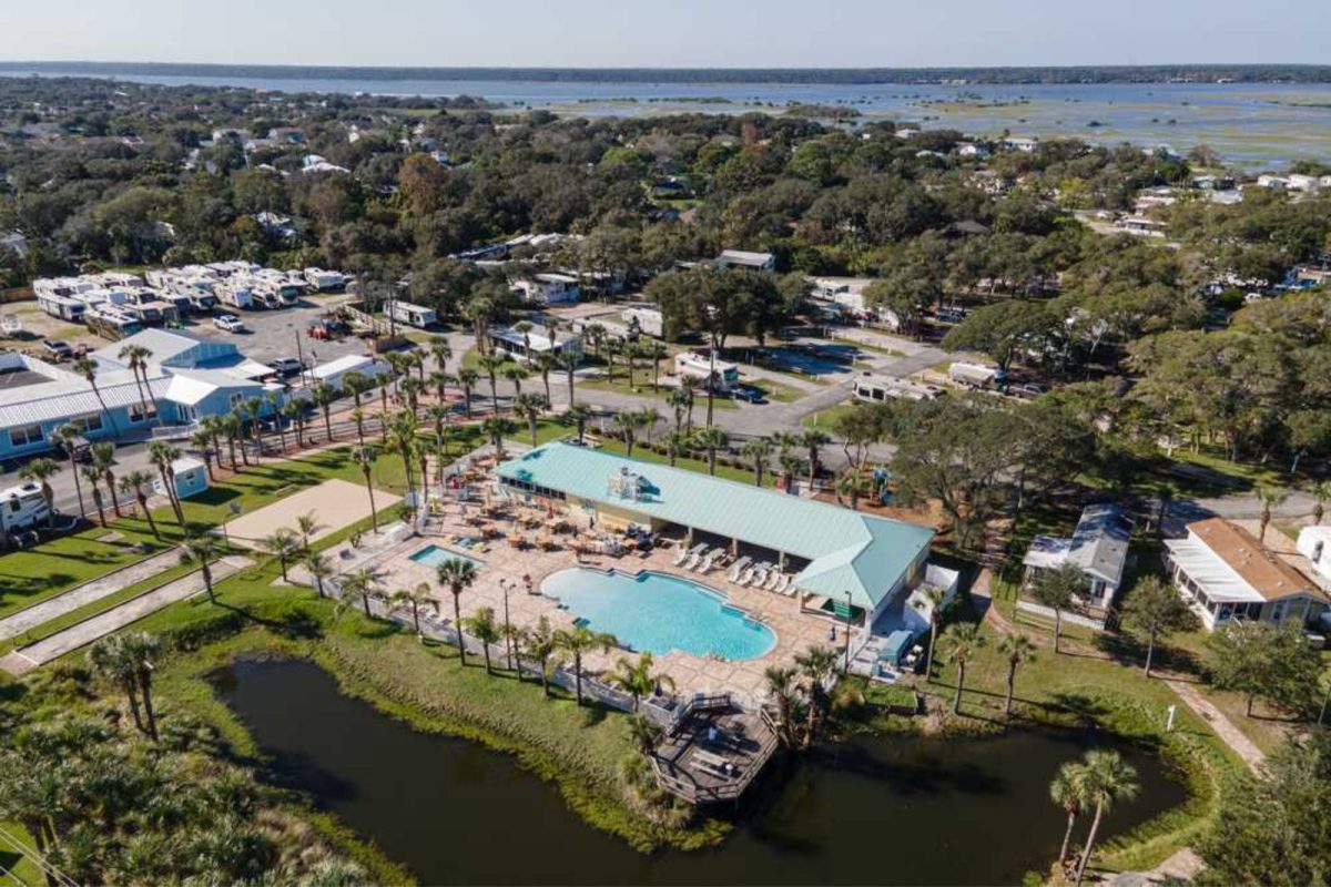 aerial view of campground near Jacksonville, FL with pool, palm trees, and lake