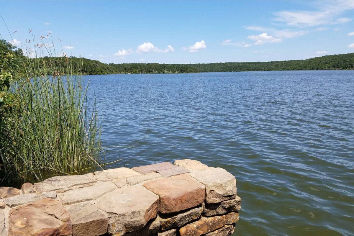 rock wall next to expansive lake