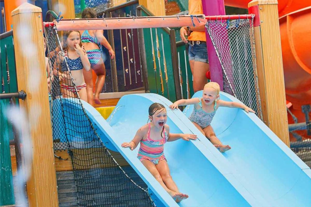 five children going down water slides