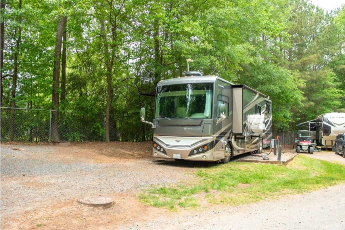 RV parked next to green trees at North Carolina campground