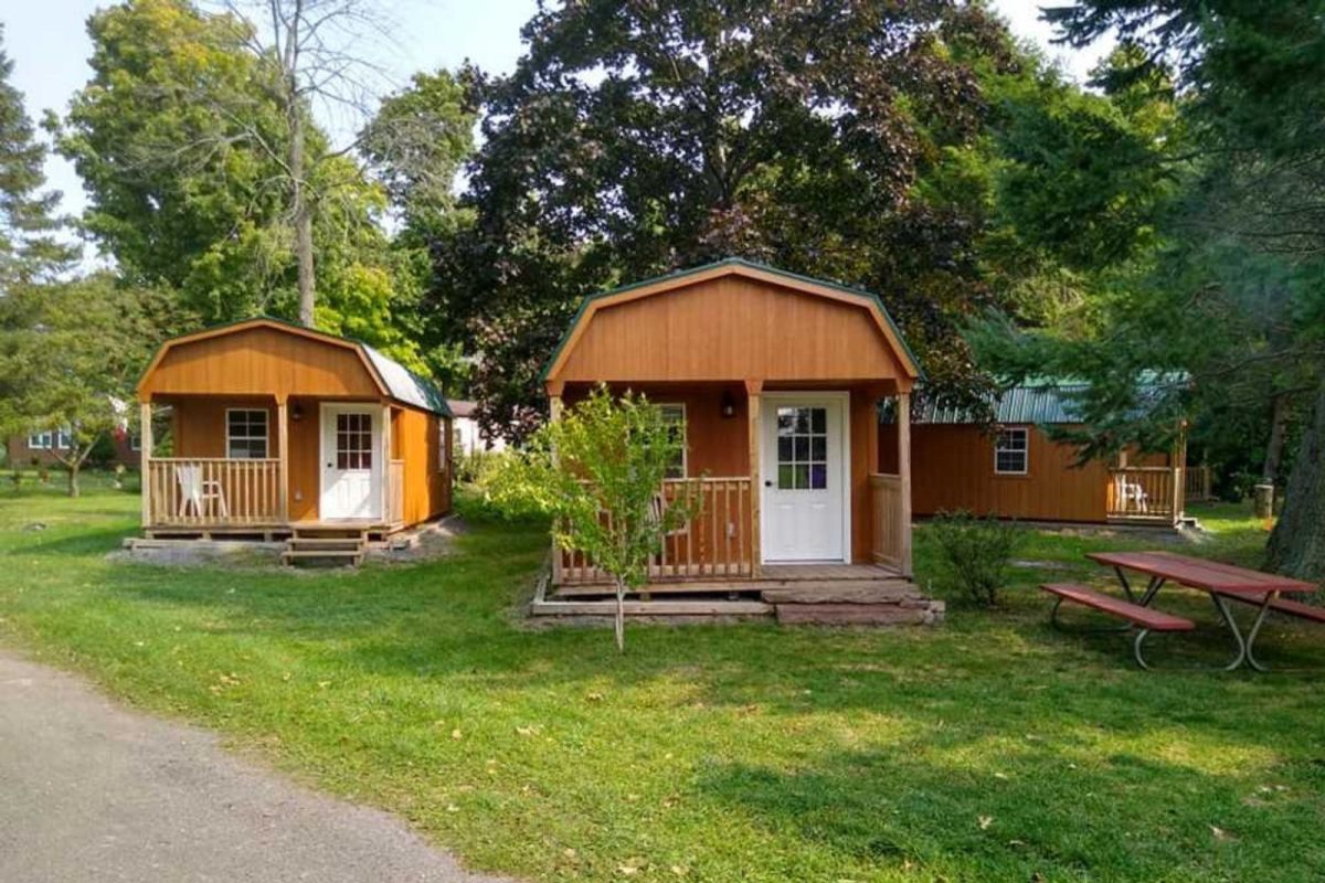 three wood cabins at campground