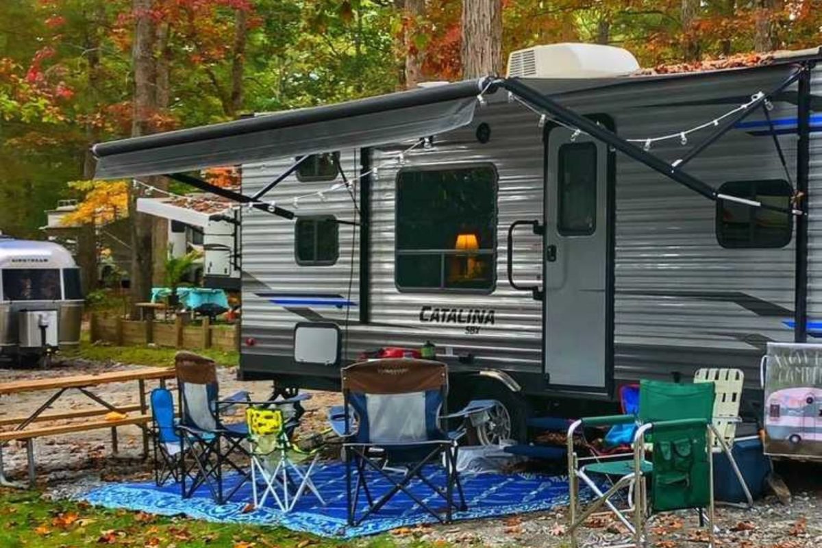 camping chairs and blanket set up by RV at campground near Asheville