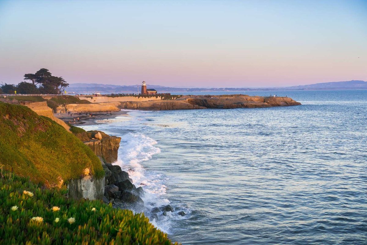 ocean waves hitting pier and cliffs at Santa Cruz near San Francisco