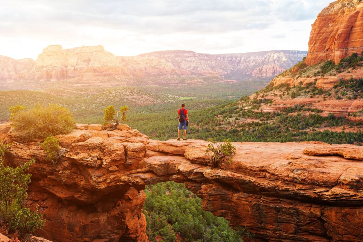 man standing on Devil's Bridge in Sedona, AZ, top spring break camping destination