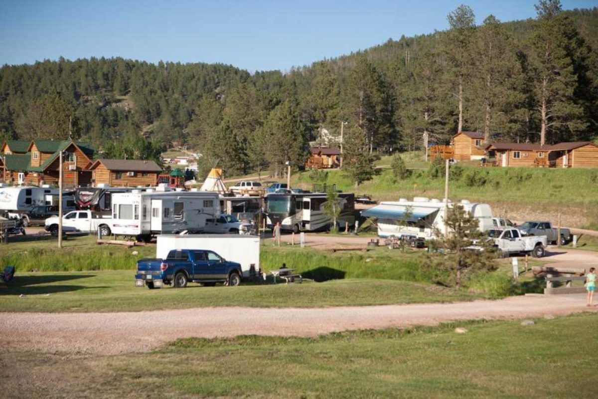 truck and RVs parked at grassy field at Black Hills Trailside Park Resort