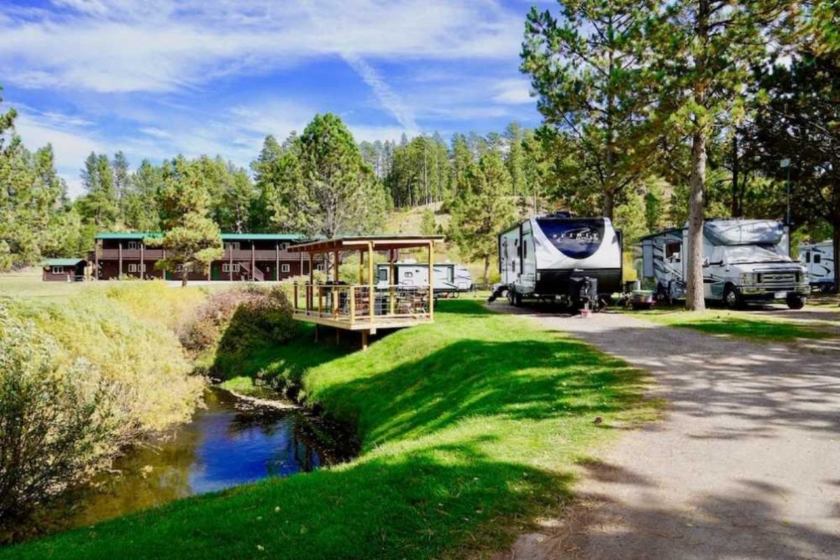 RVs parked by creek at campground near Mount Rushmore