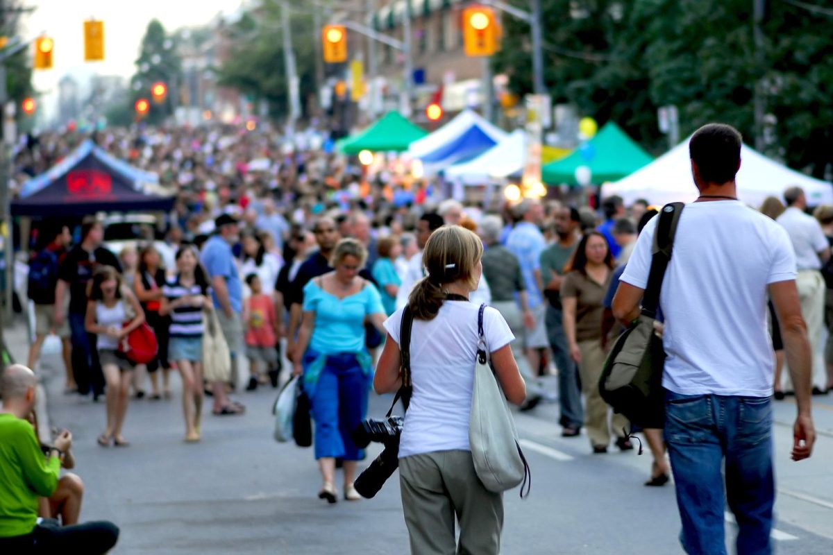 people walking in street festival