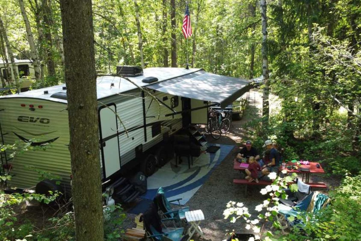 campers with RV parked at campground for Fourth of July weekend camping