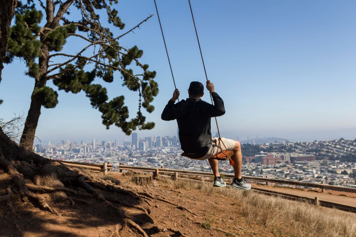 man on swings at Bernal Heights Park in San Francisco