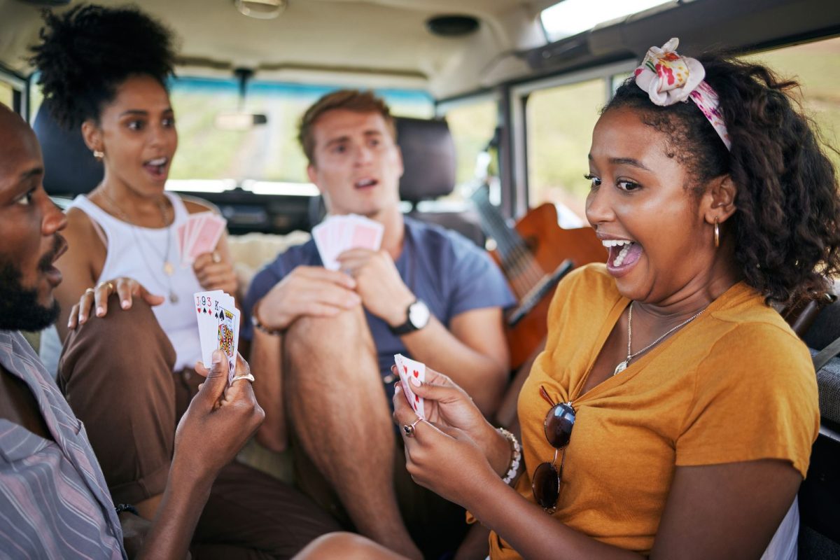 group of friends relax while camping with card games