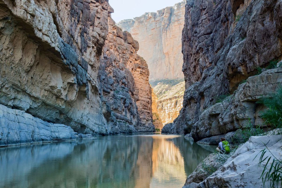 camper sitting by Rio Grande running through Big Bend National Park in Texas during winter