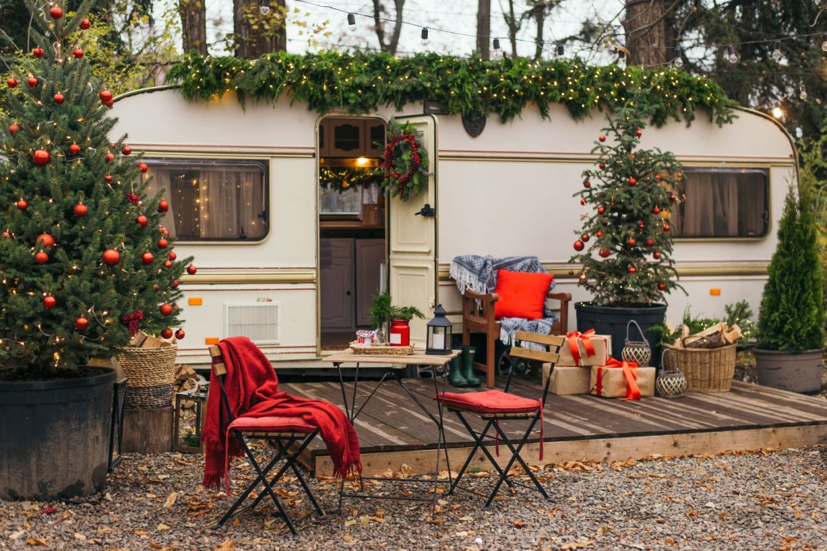 RV decorated with Christmas trees and festive decor for winter camping