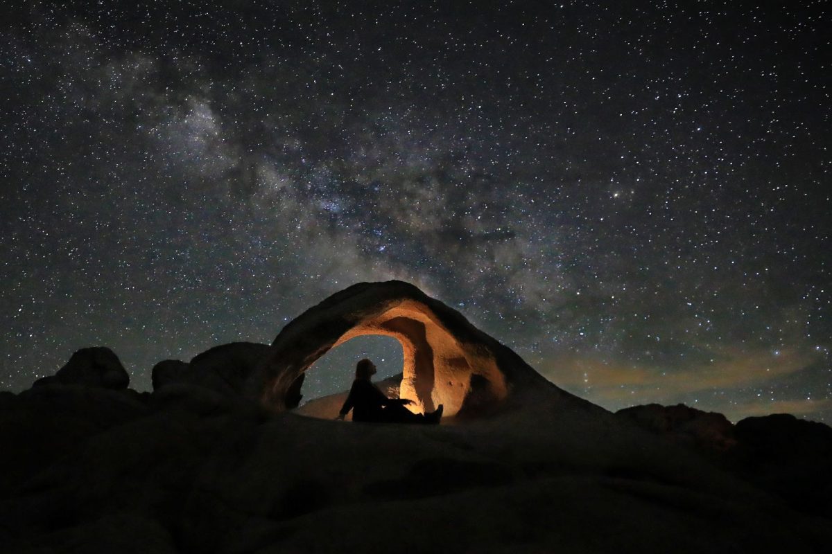 camper stargazing while camping in fall or winter at Joshua Tree National Park