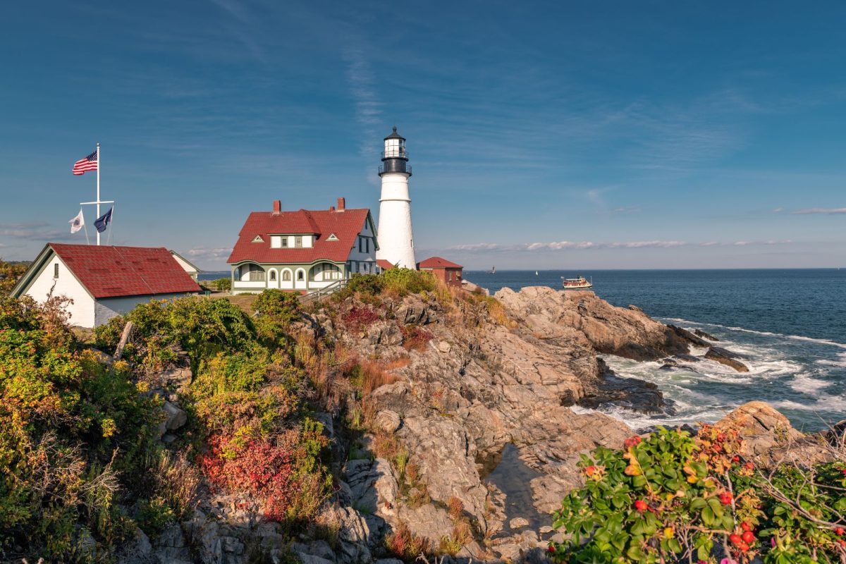 Portland Head Light overlooking cliffs of fall foliage at one of top fall camping destinations