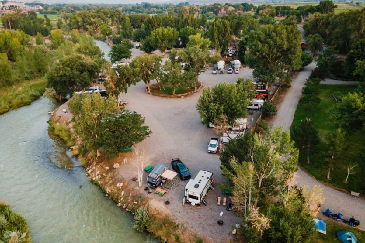 aerial view of RVs parked near river at campground Riverbend RV Park & Cabins