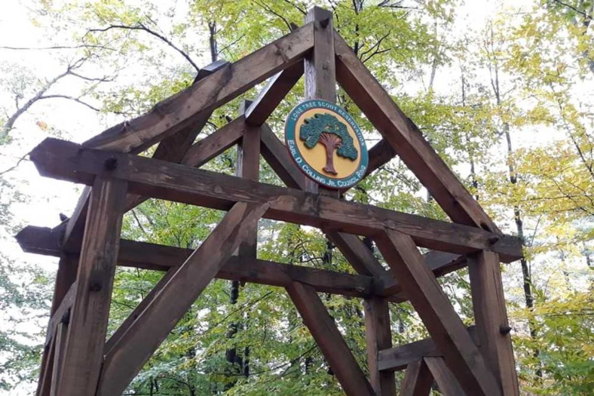 wooden structure with campground Lone Tree Reservation logo