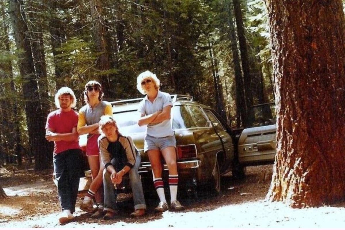 1980s campers posing in front of car