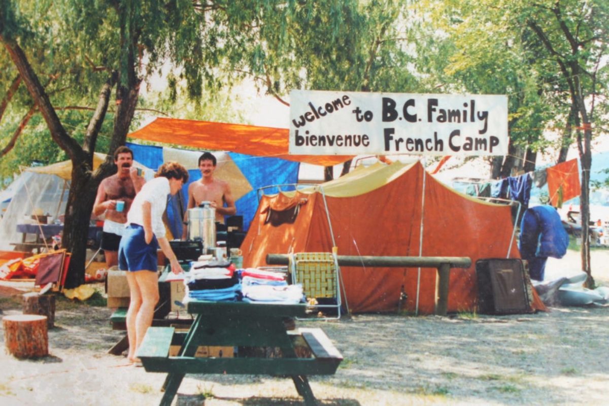 family in 1980s photo camping with bright orange tent