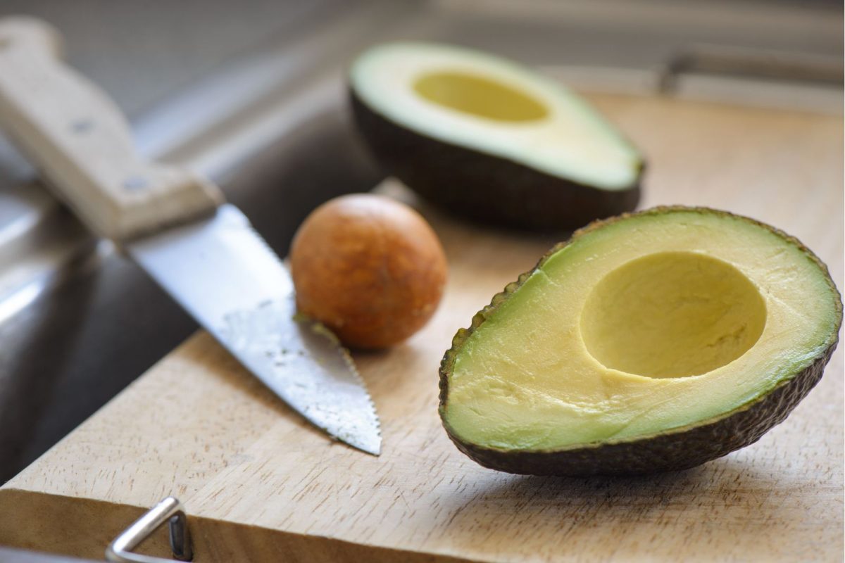 knife and avocados on cutting board over sink to save space in RV