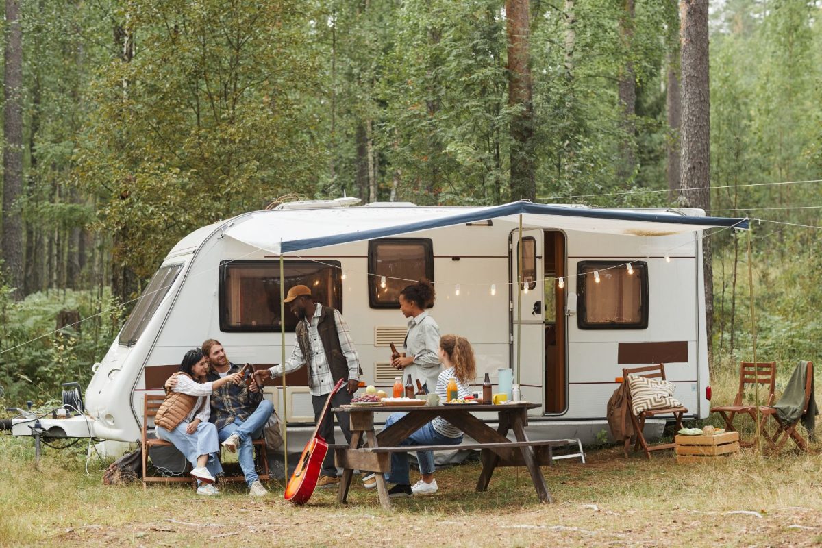 friends seated outside RV on chairs for Thanksgiving gathering