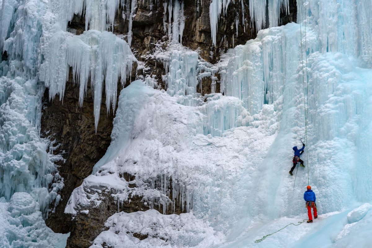 ice climbers going up cliff in Banff, Alberta, as a winter camping event