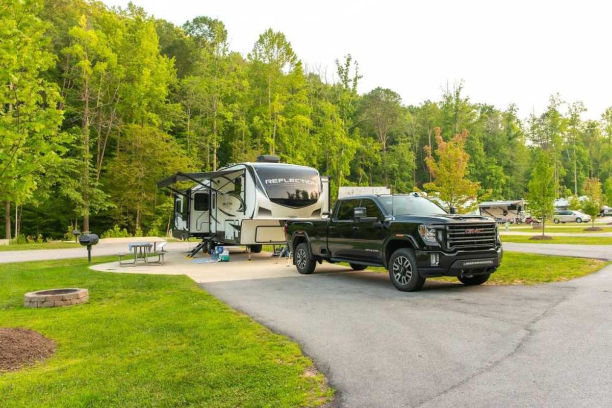 truck and RV parked in grassy spot at RV resort